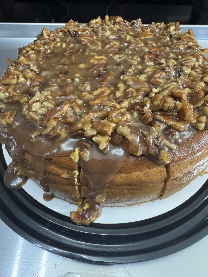 Pumpkin Pecan Pie cheesecake by Linda's Specialty Cheesecakes, topped with a glossy pecan praline topping.
